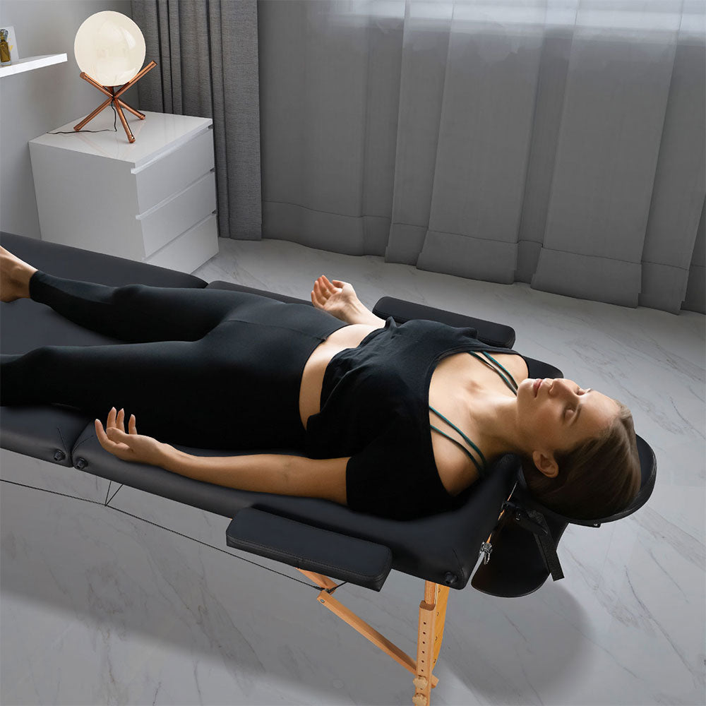 Woman relaxes on Portable Massage Table with Memory Foam