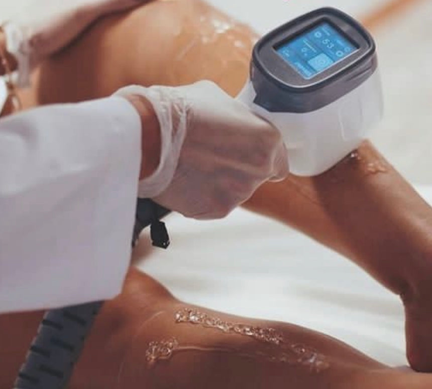 Laser hair removal treatment is performed on leg using laser machine handle with touch screen 